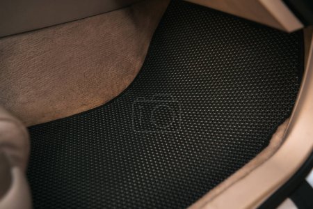 Foto de Eva floor mats car mats close up macro graphite gray. black floor mat to protect the vehicle interior. - Imagen libre de derechos
