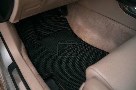Foto de Eva floor mats car mats close up macro graphite gray. black floor mat to protect the vehicle interior. - Imagen libre de derechos