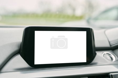Sistema moderno de la unidad principal del infotainment del coche con el teléfono, la música, y la maqueta de navegación. Primer plano de la pantalla en blanco en el interior del coche.