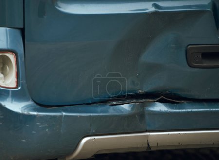 A car with a dented bumper has been damaged in road accident