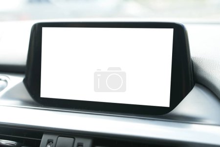 Modern car infotainment head unit system with phone, music, and navigation mockup. Close up of blank screen in car interior.