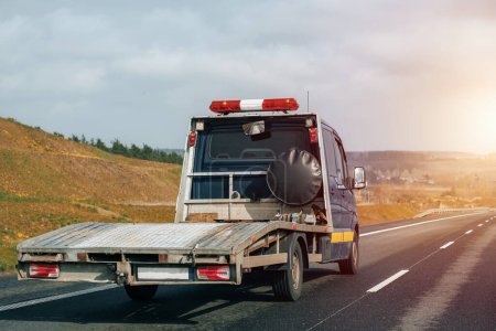 Photo for Empty tow truck with drives down a highway - Royalty Free Image