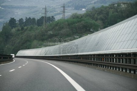Solar Highway is a noise barrier along the motorway. Solar modules along highways in Europe. Concept of sustainable future.