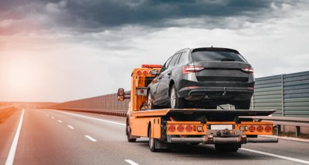 Photo for Tow truck with a broken car on a road. Tow truck transporting car on the highway. Car service transportation concept. Roadside Rescue. - Royalty Free Image