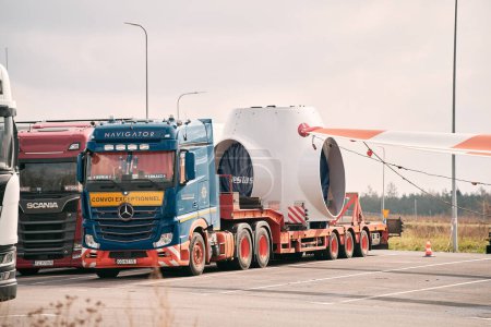Photo for 08.04.2023 Poland, Europe. A large semi truck carrying a wind turbine section on the back of it's trailer. Convoi Exceptionnel  translation: "Exceptional Convoy". Oversize load. - Royalty Free Image