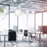 Modern Office Interior with Beautiful Lighting. Beautiful blurred abstract background of a modern office interior with beautiful lighting. Meeting background copy space template.