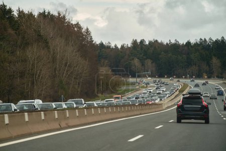 Photo for 16.04.2023 Germany, Europe. Heavy Traffic Congestion on Autobahn in Rainy Weather. Overloaded Opposite Lane and Slow-moving Commuters during Rush Hours in Germany. - Royalty Free Image