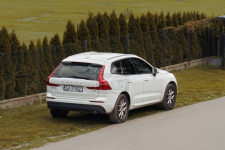 Photo for 07.08.2023. Poland, Europe. Safety and Elegance. White Volvo XC60 Parked Alongside Urban Road. A modern Swedish SUV is parked near the road. Rear view of Volvo XC60. - Royalty Free Image
