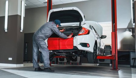 Photo for Panorama of car service. Mechanic repairing a car. Horizontal photo of car repair in the dealership. - Royalty Free Image