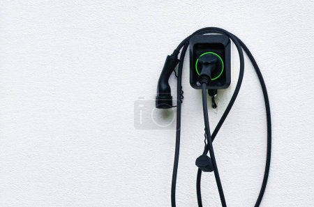Photo for Isolated close-up of wall EV charger. Recharging sustainable transport at home. EV charger in a residential house. Clean power. Future transport technology. - Royalty Free Image