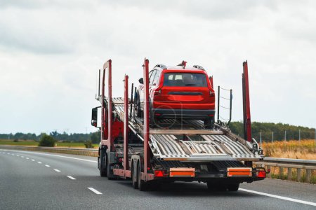 Photo for Reliable Towing and Recovery Services: 24-7 Assistance for Vehicle Breakdowns and Accidents. Emergency roadside assistance on the highway. side view of the flatbed tow truck - Royalty Free Image