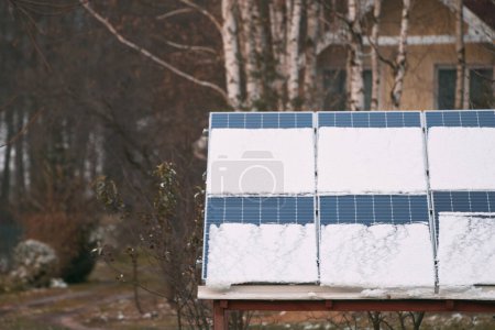Efficient and Safe Energy Generation with Photovoltaic Technology. Photovoltaic electricity installation during the winter season. Alternative energy home production in cold weather.