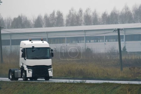 Foto de Modern white truck with diesel engine on the highway without a trailer. Semi truck isolated close-up. - Imagen libre de derechos