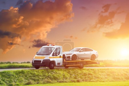 Roadside Rescue. Tow truck with a broken car on a road. Tow truck transporting car on the highway. Car service transportation concept.
