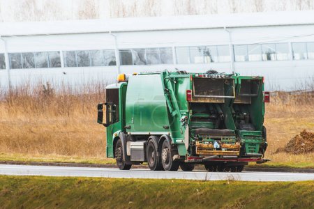 Photo for Isolated modern waste truck on the road. Sanitation industry. Municipal waste management - Royalty Free Image