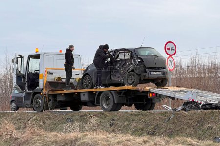 Photo for 02.02.2024 Poland, Europe. T-Bone Car Accident. Side crashed modern family car. Tow truck with a broken car on a road. Tow truck loading a car on the highway. Road accident site. - Royalty Free Image