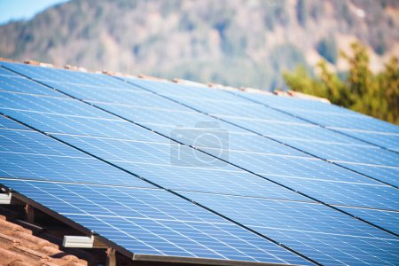 Photo for Alpine Home with Solar Panels. Harnessing Sunlight for Energy - Royalty Free Image