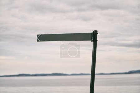 Signpost Awaits Direction on a Calm Seascape Horizon