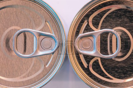 Photo for Shiny aluminum can lids facing off in close view. - Royalty Free Image