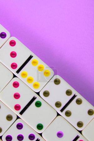 Photo for Close up view of white dominoes on violet background. - Royalty Free Image