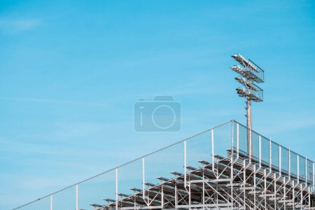 Photo for Strong lights and empty bleachers at sporting venue - Royalty Free Image