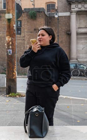 Photo for Rome, Italy - October 22, 2022: Narrow streets in the center of Rome. Girl talking on a mobile phone - Royalty Free Image