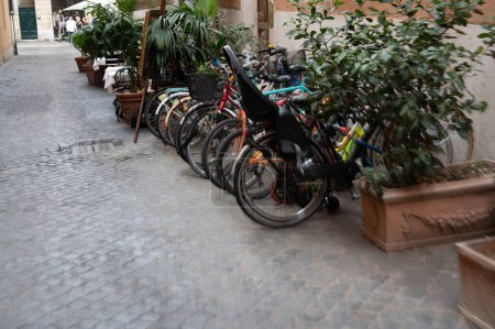 Photo for Rome, Italy - October 22, 2022: Narrow streets in the center of Rome. residential areas. Paved sidewalk. Parking for bicycles. - Royalty Free Image