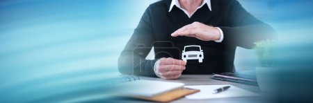 Photo for Insurer protecting a car with his hand; panoramic banner - Royalty Free Image