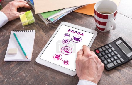 Man using a tablet showing a fafsa concept