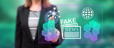 Photo for Woman touching a fake news concept on a touch screen with her fingers - Royalty Free Image