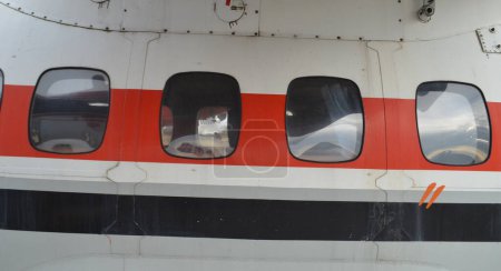 Photo for The photograph shows the windows of an ordinary flying, working passenger aircraft without embellishment. - Royalty Free Image
