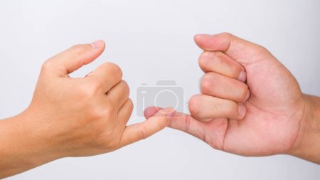 Photo for Man and woman making promise as a friendship concept or pinky swear hands sign isolated on white background. - Royalty Free Image