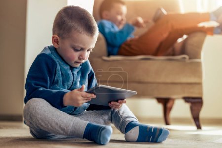 Photo for Happy children playing video games at home. - Royalty Free Image