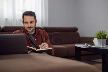 Photo for Man using laptop, writing email,online meeting or payment online.Freelancer working from home office. - Royalty Free Image