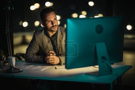Photo for Portrait of businessman working at office over time late at night - Royalty Free Image