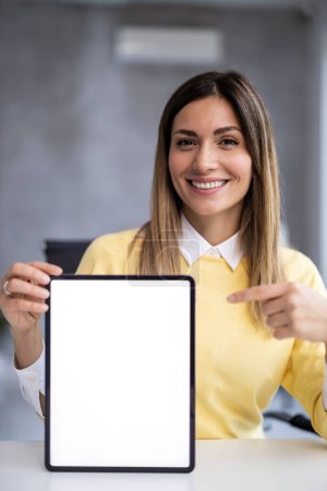 Photo for Young businesswoman holding digital tablet with white screen.People,business and technology concept. - Royalty Free Image