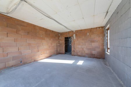 Photo for Unfinished room interior of building under construction. Brick red walls. New home. - Royalty Free Image