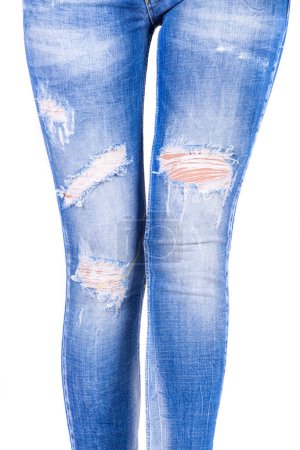 Foto de Woman blue jeans, ripped destroyed. Female legs in jeans denim Jeans ripped destroyed. - Imagen libre de derechos