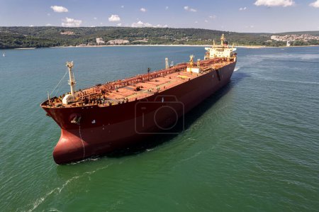 Photo for Aerial view of a red oil tanker leaves the port. Tanker ship logistic and transportation business oil and gas industry. - Royalty Free Image
