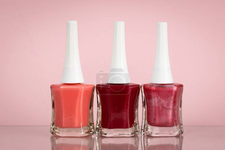 Photo for Group of bright nail polishes in different colors on pink background - Royalty Free Image