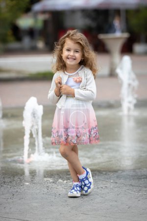 Photo for Cute little girl posing and smiling - Royalty Free Image