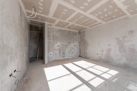 Photo for New empty room under construction. Plaster walls. New home. Concrete walls. Interior renovation. - Royalty Free Image