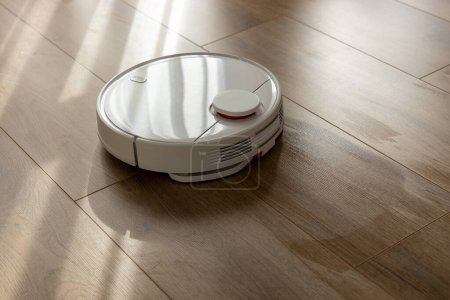 Vacuum Robot cleaning at home. Robot vacuum cleaner in the modern home. Smart cleaning technology