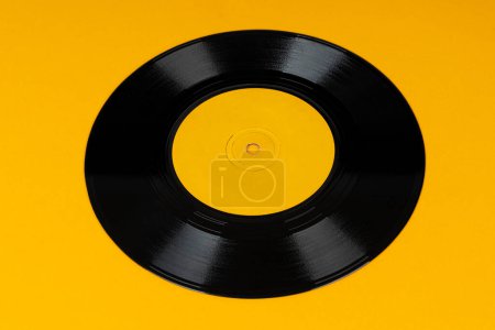 Photo for Old vinyl disc on yellow background. Old vintage vinyl record. - Royalty Free Image