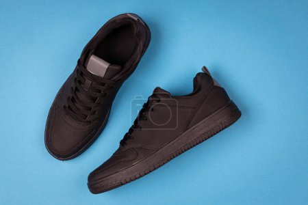 Photo for Black leather shoes on blue background. Sport shoes - Royalty Free Image