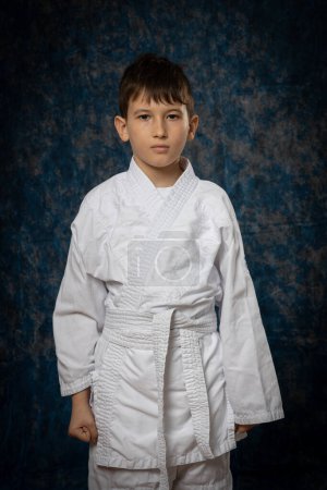 Photo for Boy posing in white kimono on black background - Royalty Free Image