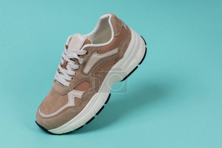Photo for Casual shoes on green background. Women's sports shoe. - Royalty Free Image