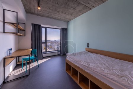 Photo for Simple student-style dorm bedroom. Hostel dormitory room. Campus - Royalty Free Image
