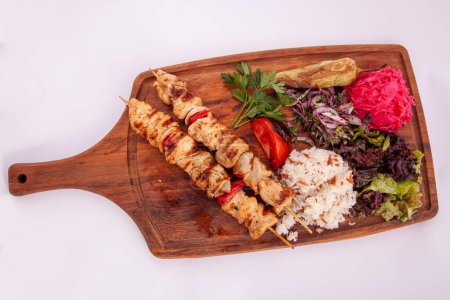Photo for Chicken skewers with vetables on wooden board - Royalty Free Image