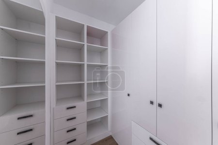 Photo for Empty wardrobe in dressing room. Wardrobe room, with empty shelves. Interior of modern empty dressing room, wardrobe. - Royalty Free Image